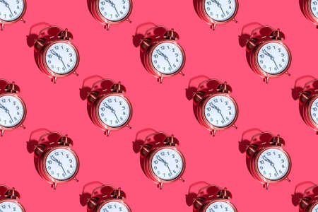 Alarm clock on a colored background with hard shadows. Close up. Seamless patternsの写真素材