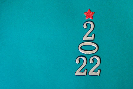Holiday concept. Christmas background, golden numbers 2022 with red bow and star. Happy New Year.の写真素材