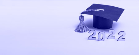 Gift box in the form of a graduation cap. 2022 release concept on very peri background with copy...