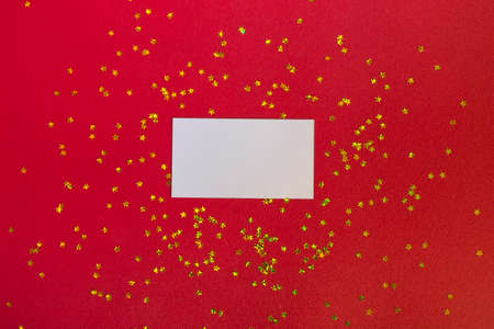 Mockup of a business card or postcard with gold stars ornaments on a bright red background. Flat style, planning conceptの写真素材