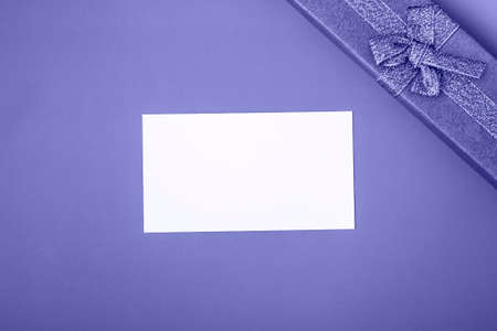 Gift box with tie and card on a very peri background. Holiday gifts close up with copy spaceの写真素材