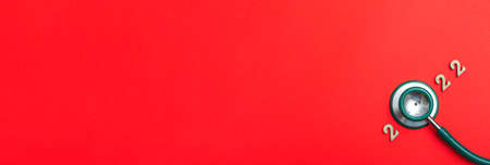 Stethoscope number 2022 on red background creative idea new trend medical banner calendar cover...