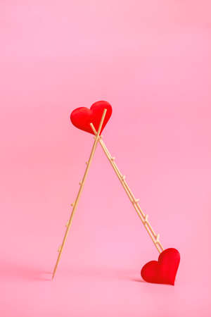Wooden ladder with red hearts on a pink background. Postcard or invitation template. Close up. Vertical formatの写真素材