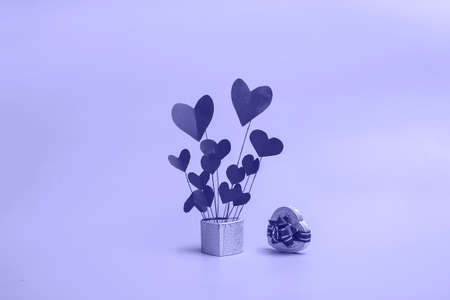 Gift box in the shape of a heart with flying hearts on a pink background. Banner for valentines day or mothers day with copy space.の写真素材