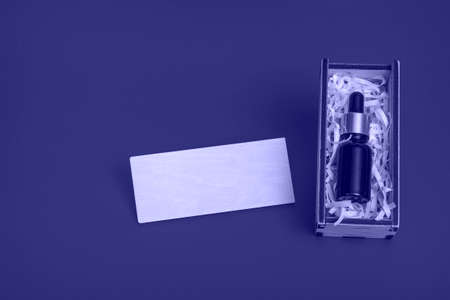 On a very peri background, a gift bag with cosmetics. With copy space, closeup