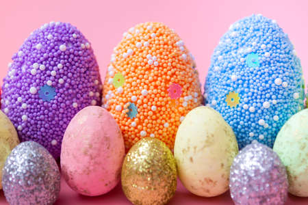 Stylish Easter eggs on a pink background. Greeting card template. With copy space. close upの写真素材