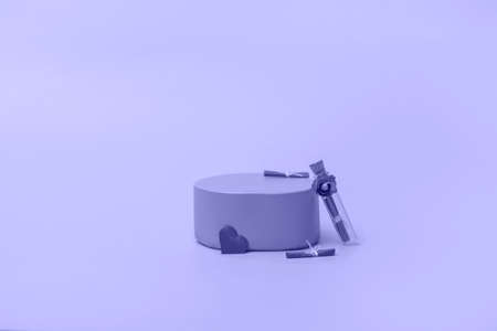 Pink podium for cosmetics or products with flowers and hearts on a very peri background. Holiday card, close up copy spaceの写真素材