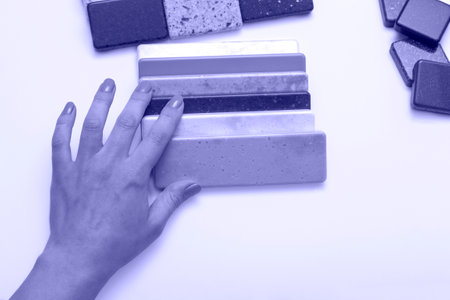 Mock up from natural stones, top view, close up. Female hands advertises repair materials. Floor tiles, tiles, countertops.の写真素材