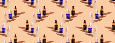 Cosmetic bottle mockup with cosmetics on beige pastel background with hard shadows, copy space closeup. Seamless patternの写真素材