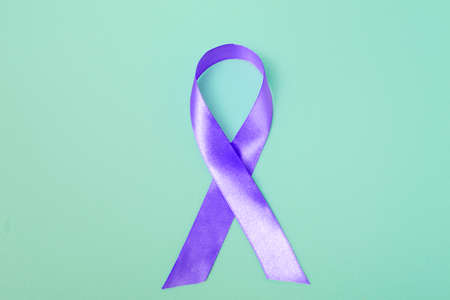 Close up purple ribbon on a blue background with copy space. World epilepsy day.Bannerの写真素材