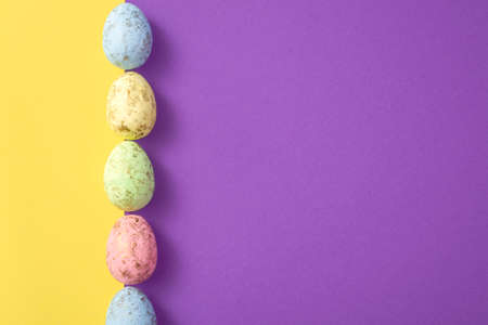 Easter eggs on a colored background. Festive banner with copy spaceの写真素材