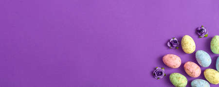 Easter eggs on a colored background. Festive banner with copy spaceの写真素材