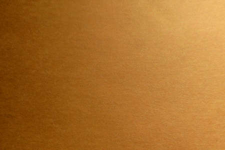 Paper textured background. The color of the paper is orange. Place for textの写真素材
