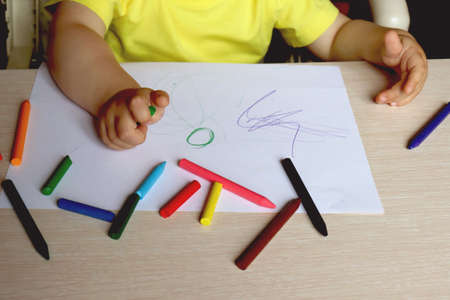 Cropped portrait of young child drawing picture with colored pencils, copy spaceの写真素材