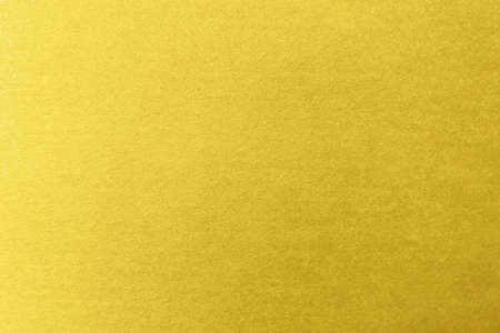 The texture of gold-colored paper with sparkles. Place for your textの写真素材