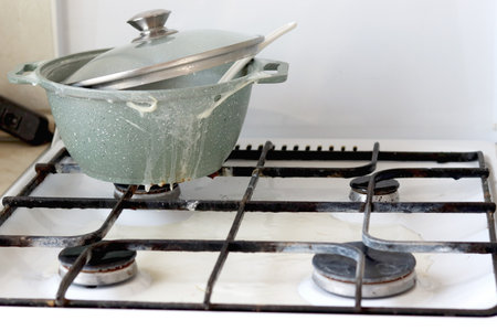 A dirty pot is on the stove. Saucepan with porridge spots.の写真素材