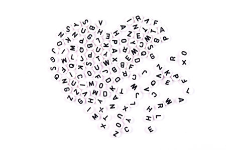 The heart assembled from letters is destroyed. Letters as a symbol of reading. Reading English Literature. Learning to read. Concept - love for books, study and schoolの写真素材