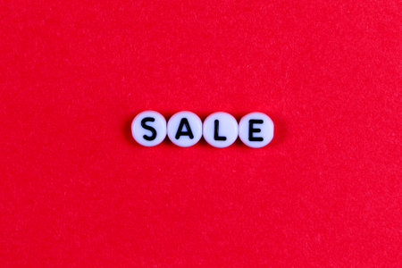 The inscription SALE on a red paper background. Advertising, postcard, banner.の写真素材