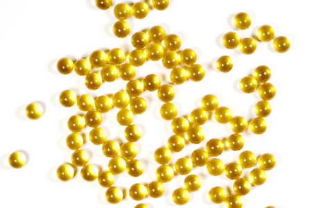 Yellow transparent vitamin balls on a white background. The concept of medicine and healthの写真素材