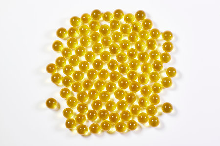 Yellow transparent vitamin balls on a white background. The concept of medicine and healthの写真素材