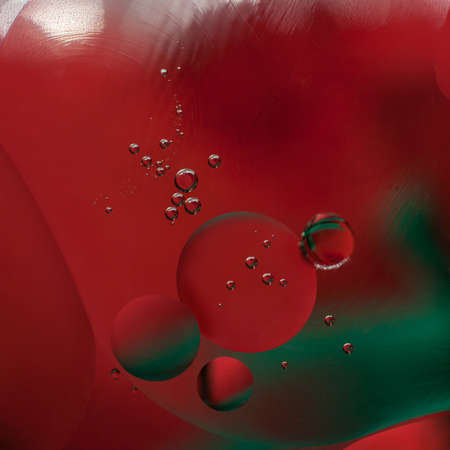 Abstract art - a shot of red and green round oil drops close-up. abstract backgroundの写真素材