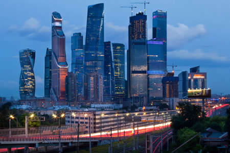 Moscow City, business district of skyscrapers at dusk, evening lights, roads around it, Moscow, Russiaの写真素材