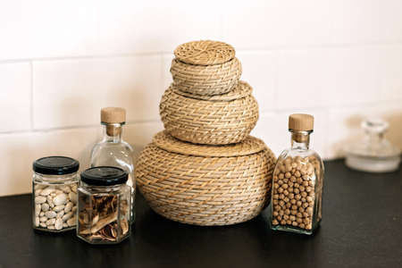 Kitchen utensils, wooden wicker baskets and spices. Soft selective focus.