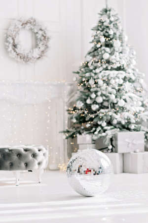 Festive interior. Luxurious Christmas tree decorated with lights with gifts. Happy New Year 2021. Christmas concept. Soft selective focus. Copy space.の写真素材