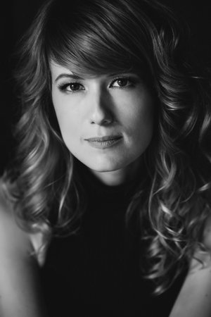 Portrait of a 36 year old woman with curly hair and brown slanting eyes. Soft selective focus. Black and white art photo.の写真素材