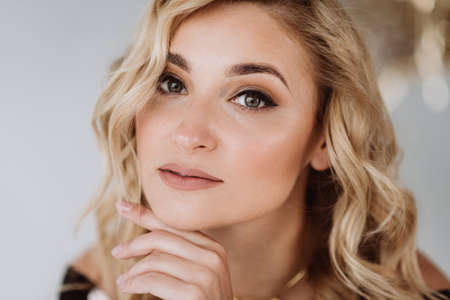 Portrait of a beautiful young blonde woman with clean fair skin. Industry of cosmetology and beauty. Soft selective focus.の写真素材