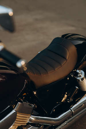 Leather motorcycle seat, close-up. Stylish custom chopper motobike with chrome details. Soft selective focus.の写真素材