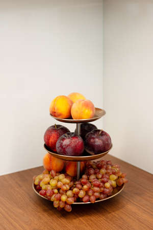 Multi-tiered fruit plate in the kitchen. Healthy eating. Soft collapsible focus.の写真素材
