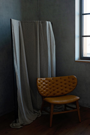 Modern leather armchair of red color in a loft interior. Soft selective focus.の写真素材