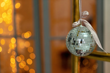 Close-up of a festive Christmas ball toy on a blurred sparkling fairy tale background. Defocused garlands, bokeh effect. Defocus, soft selective focus. Copy space.の写真素材
