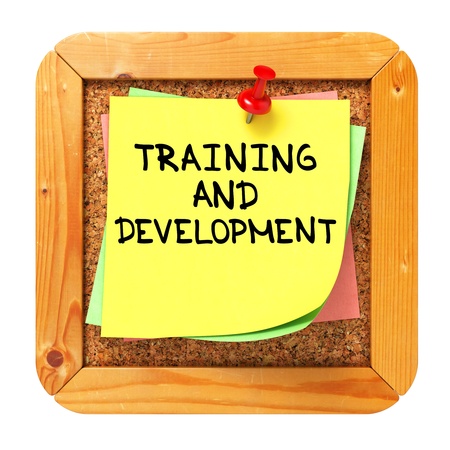 Training and Development, Yellow Sticker on Cork Bulletin or Message Board  Business Concept  3D Render の写真素材