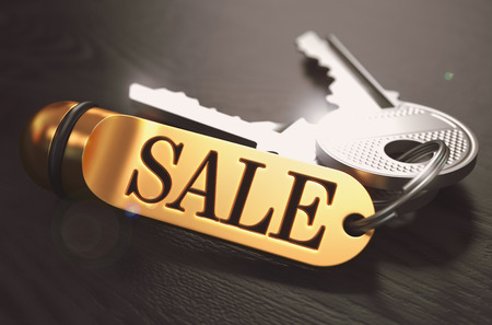 Sale - Bunch of Keys with Text on Golden Keychain. Black Wooden Background. Closeup View with Selective Focus. 3D Illustration. Toned Image.の写真素材
