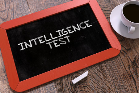 Intelligence Test Concept Hand Drawn on Red Chalkboard on Wooden Table. Business Background. Top View.の写真素材
