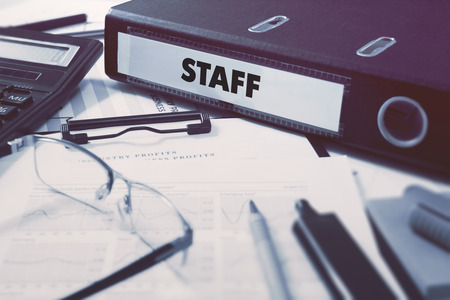 Office folder with inscription Staff on Office Desktop with Office Supplies. Business Concept on Blurred Background. Toned Image.の写真素材