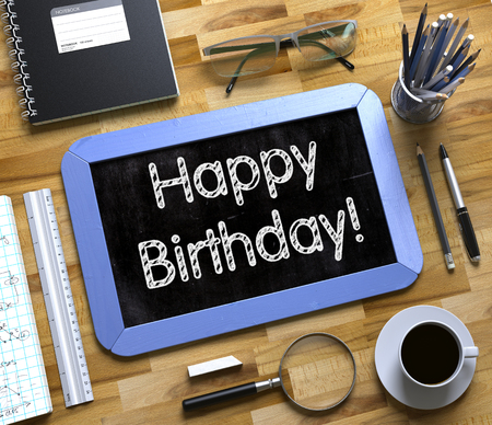Happy Birthday Handwritten on Blue Small Chalkboard. Top View of Wooden Office Desk with a Lot of Business and Office Supplies on It. Happy Birthday - Text on Small Chalkboard.3d Rendering.の写真素材