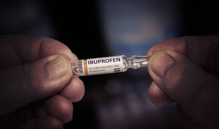 KYIV, UKRAINE-DECEMBER, 2019: Injection of Ibuprofen. Glass Ampoule in a Old Male Hands. Health Care of Older People. Close Up Photo.の素材 [FY310140724944]