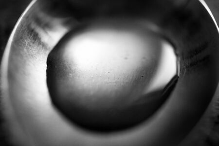 Water Drop in Old Metal Spoon. Macro Photo with Selective Focus.の写真素材