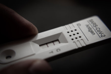 Positive Test Result by Using Rapid Test Device for COVID-19, SARS-CoV-2の写真素材