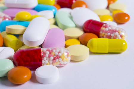 pills and capsules on light background