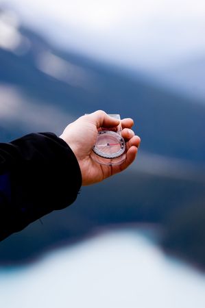 Hand with compass in the mountainsの写真素材