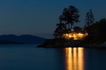 Lighted house on Pacific coast, Washington stateの写真素材