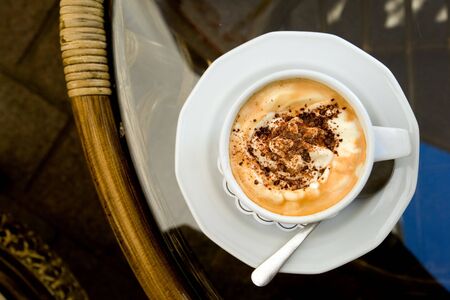 Cup of cappuccino on a table in Krakow outdoor cafeの写真素材