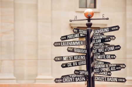 Famous signpost with directions to world landmarks in Pioneer Courthouse Square, Portland, Oregonの写真素材