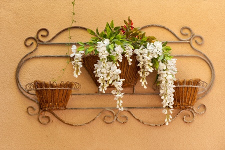 Iron flower decoration on the stucco wall, New Mexicoの写真素材