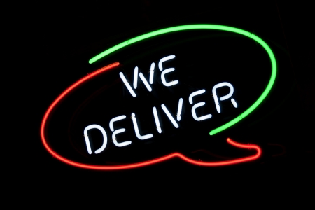 We Deliver sign in Italian colors on pizzeria s windowの写真素材