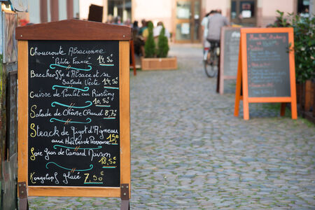 Menu stand with local specialties on Strasbourg streetの写真素材